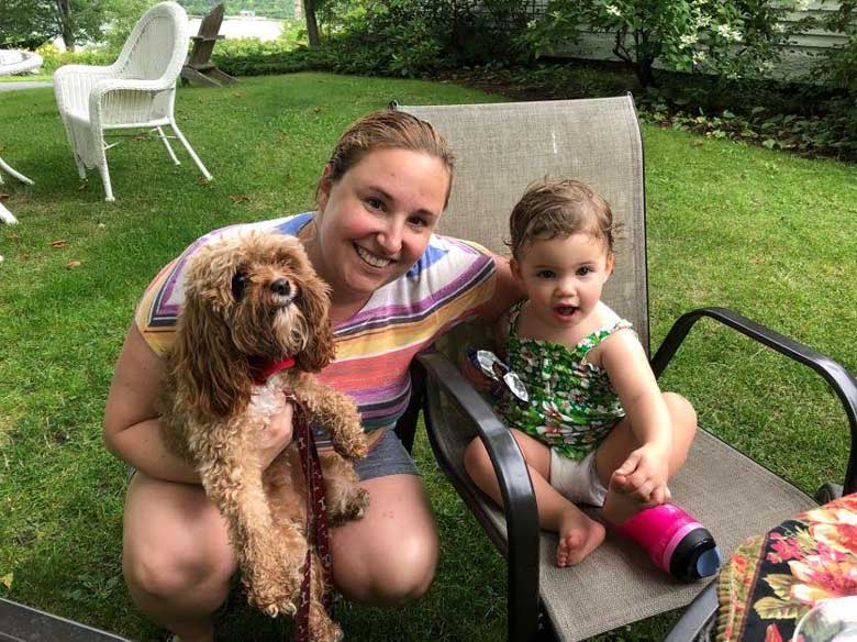 smiling family with dog