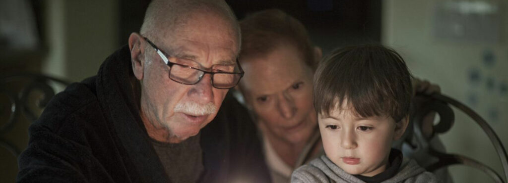 grandparents and grandchild lighting candles