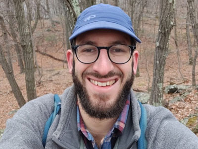 man smiling in the woods