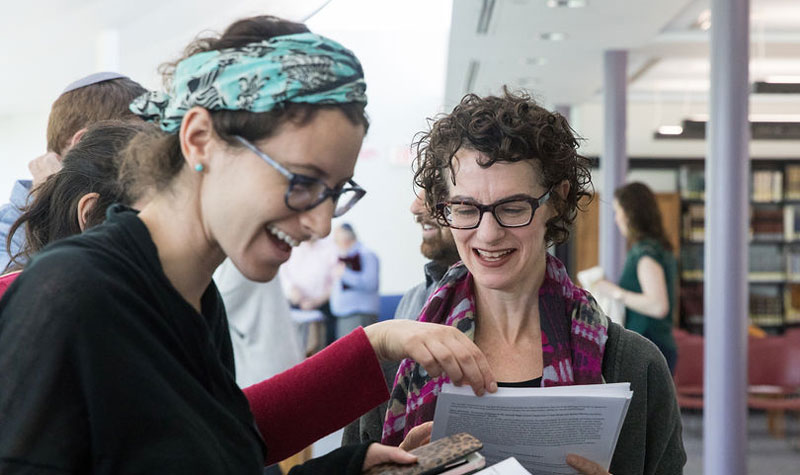 Jane Kanarek and a studnt looked at a book