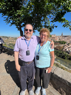 smiling couple with Spanish city in the background