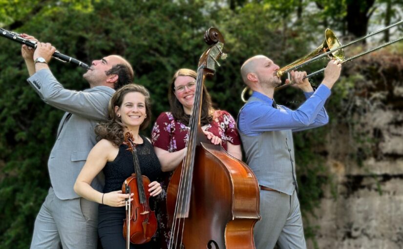 Photo of four-person band outside with their instruments
