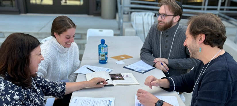 BYB fellows talk around table in HC courtyard