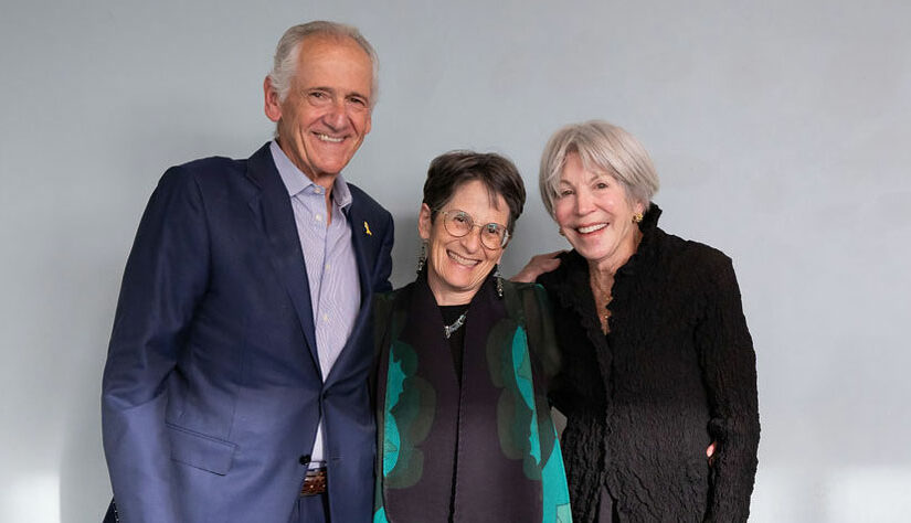 three adults smiling