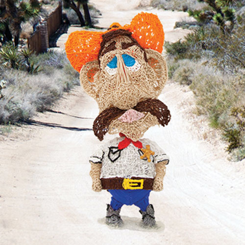 Cowboy stuffed animal creating 3D art with a bobblehead pen on dirt road. | stencil