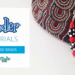 Close-up of a beaded handle purse with 3D pen art key.