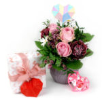 Table with flowers and gift, enhanced with 3D pen art.