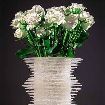 White rose-filled vase on table, rendered with 3D pen art. | stencil