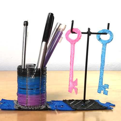 Colorful 3D pens and pen cup on desk | stencil