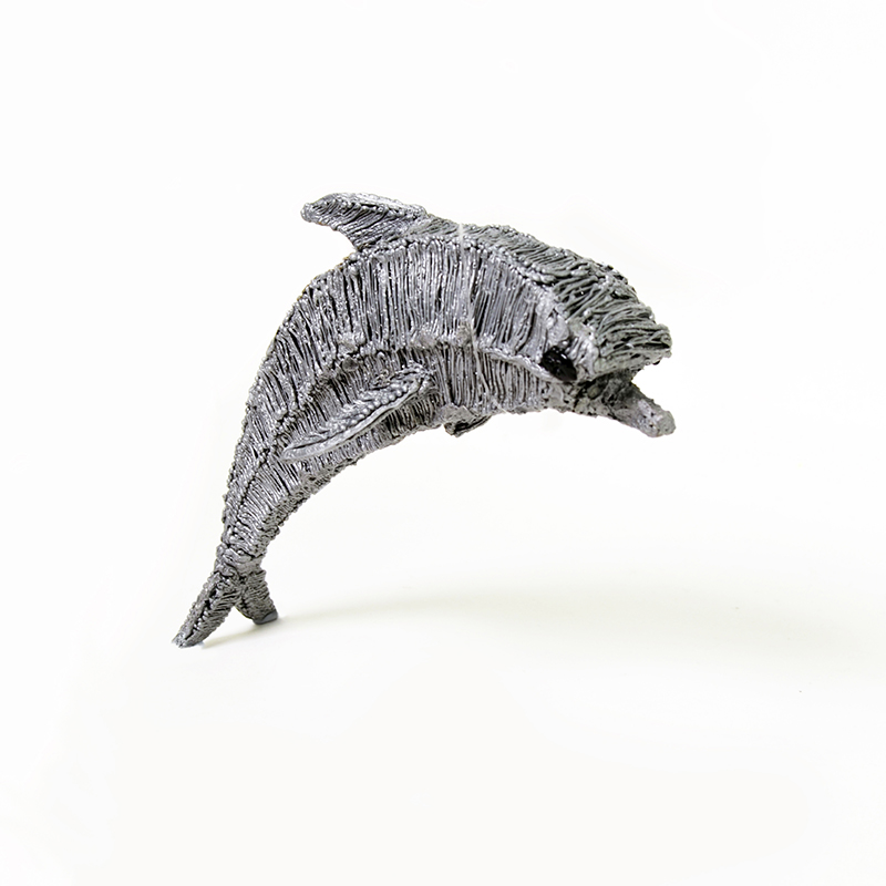 Metal dolphin on white surface, a 3D pen artwork.