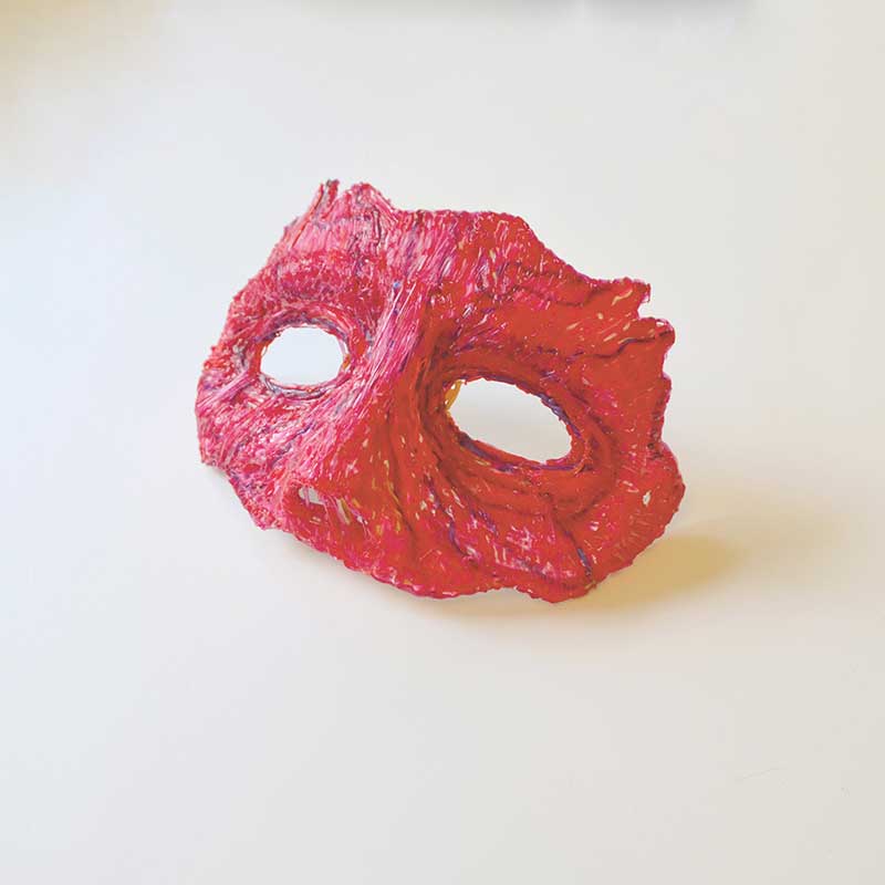 3D pen creates red Halloween mask on table