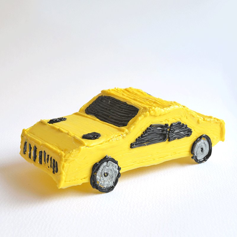 3Doodler masterpiece: yellow car cake with black wheels.