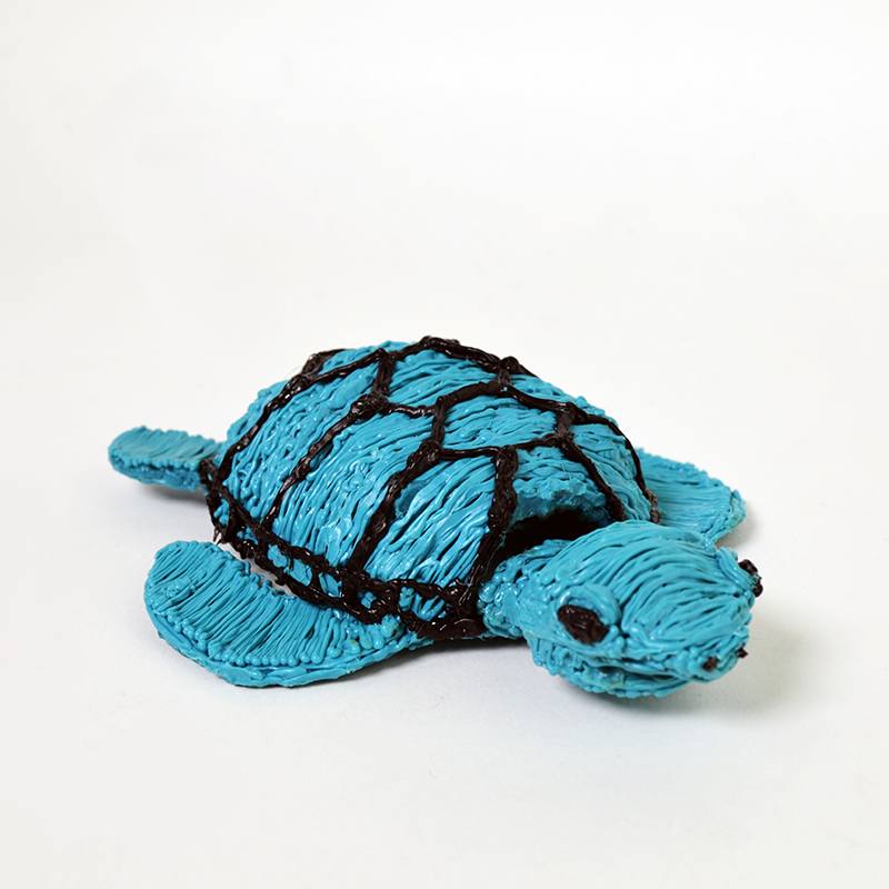 Blue turtle cake with black stripes, created using a 3D pen. | stencil