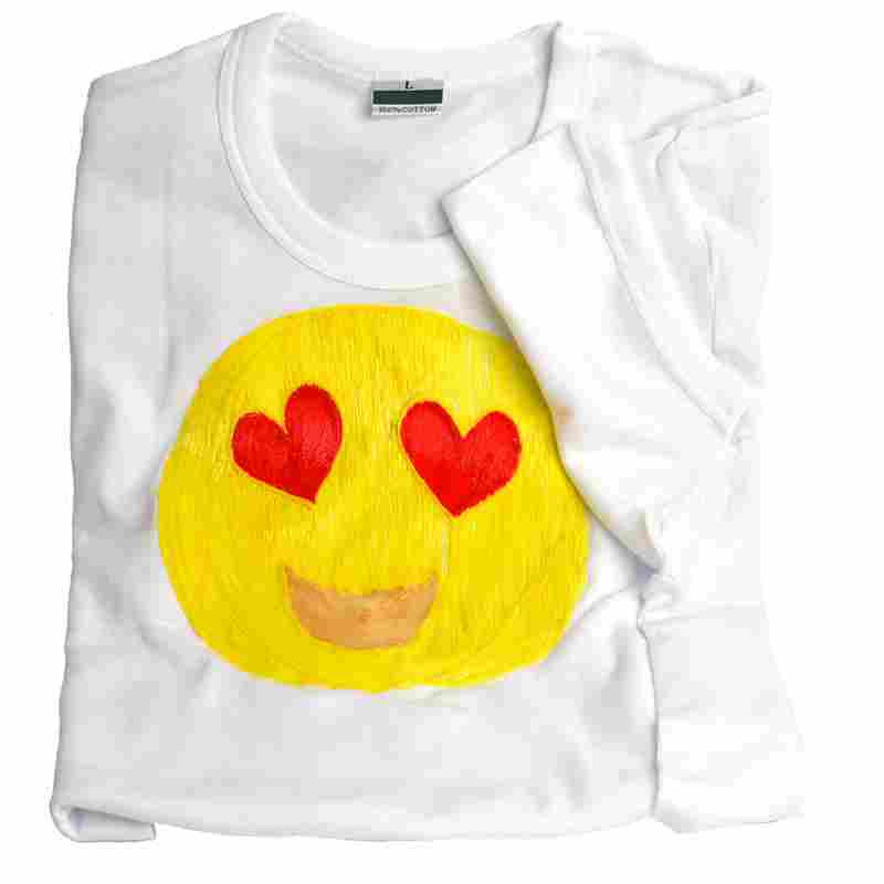 Close up of white 3Doodler smiley face T-shirt. | stencil