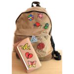 3D pen art featuring mixed symbols, backpack, book, and wallet on table