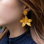 Yellow 3D pen art shows woman with gold earrings