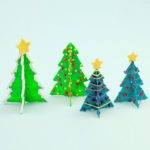 3D pen art: Row of three Christmas trees on a white surface.