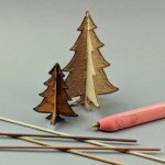 3D pen art: wooden and filament tree designs on a table