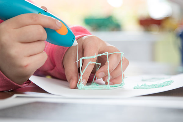 3D pen creating art on paper