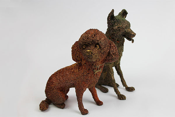 Two sitting dog sculptures in 3D pen art.