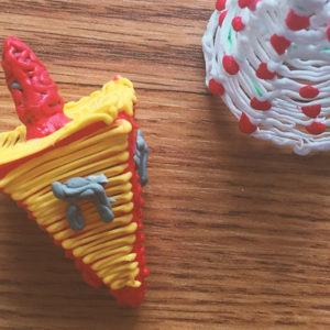 3D pen art: Dradel, cake, and cupcake on a table