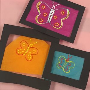 Framed butterfly art on 3D pen backdrop.