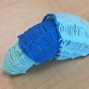 Blue and white 3D pen art on table.