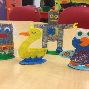 IMG_7583 - 3Doodler Table showcasing 3D pen art: variety of plastic toy designs.