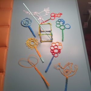 Colorful 3D pen sticks and pen on table
