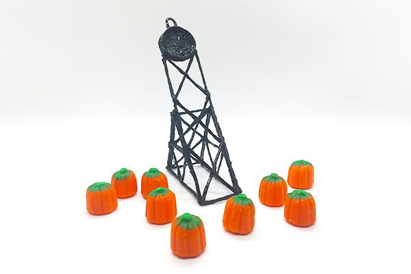 3Doodler pen catapult launching mini pumpkins, with tower and pumpkins in front.