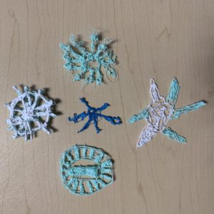 Close-up table with 4 crocheted snowflakes - 3D pen art