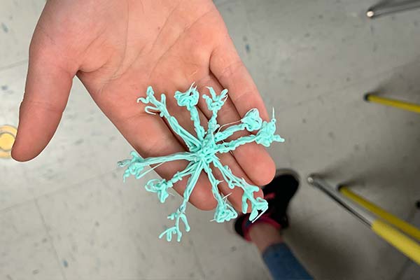 Snowflake held in hand. 3D pen art.