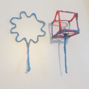 3D pen artwork: small red and blue object on wall.