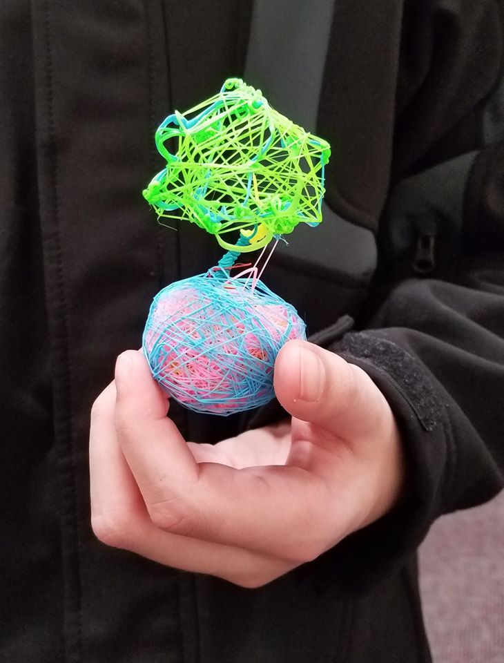 3D pen art: Person holding plant in a string ball.