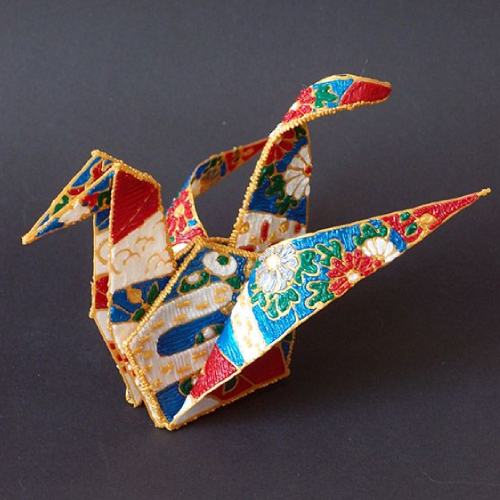 Colorful origami bird in 3D pen art on black surface