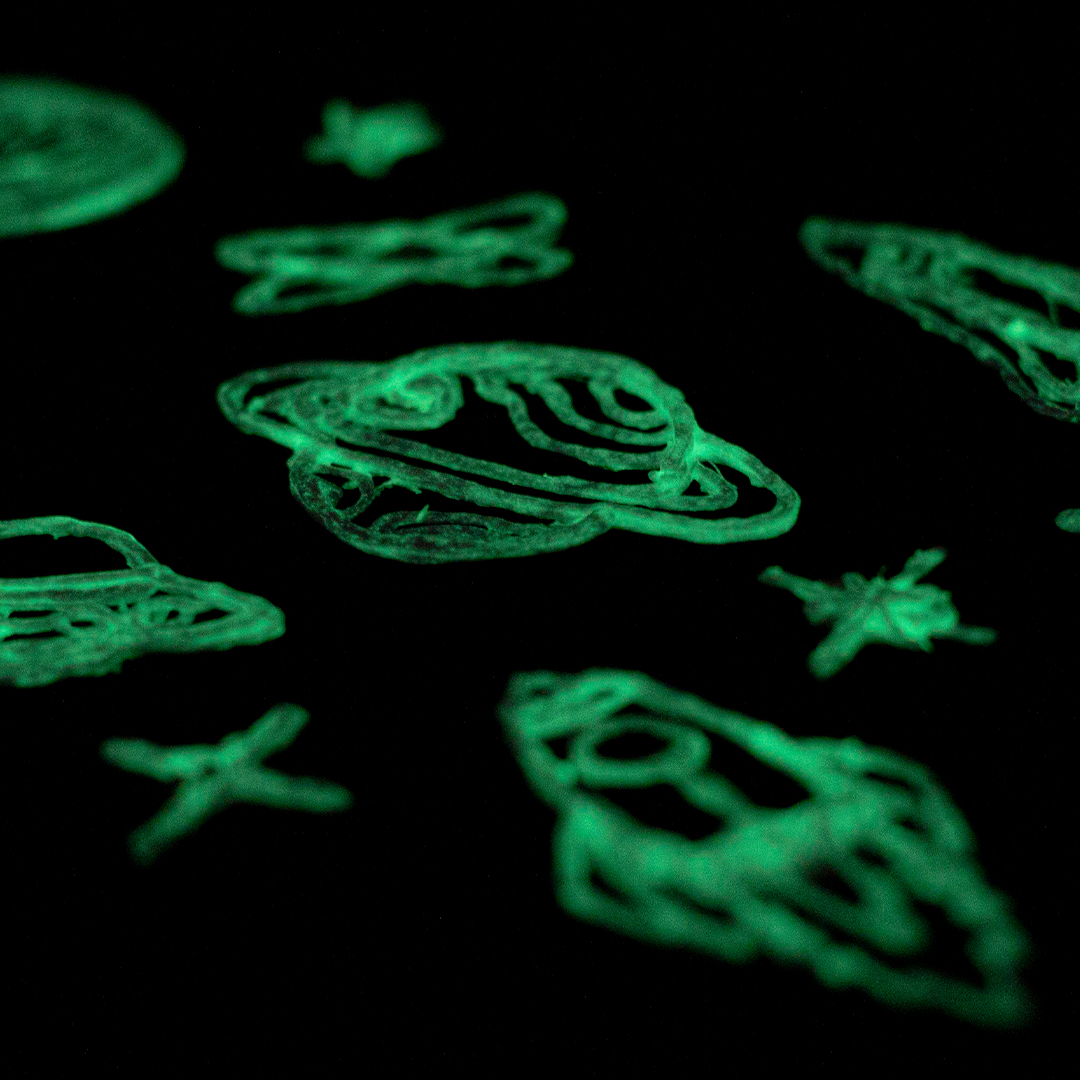 Close-up black surface with green glow in 3D pen art.