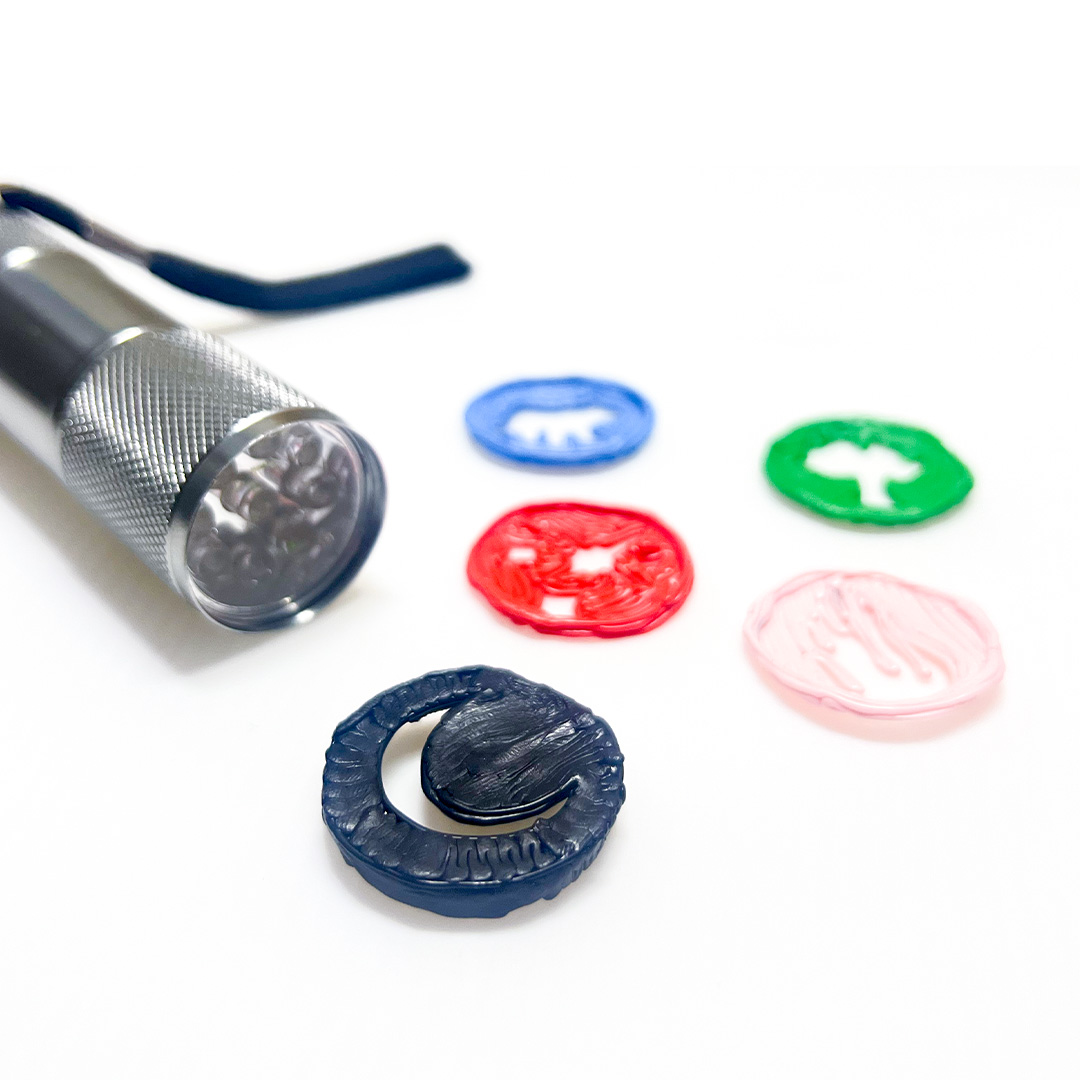 Flashlight and bottle cap on white surface - 3D pen art