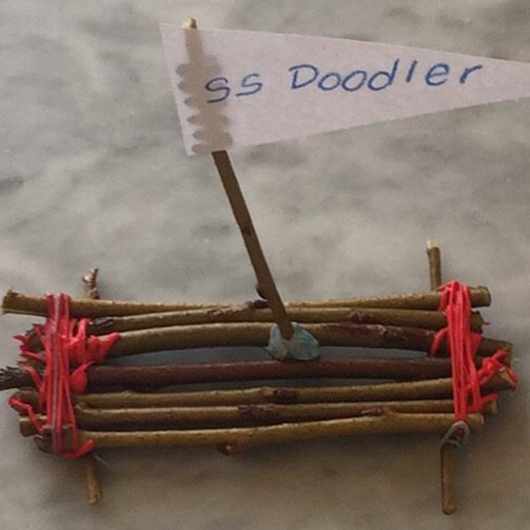 Mini wooden boat with flag, crafted using a 3D pen.