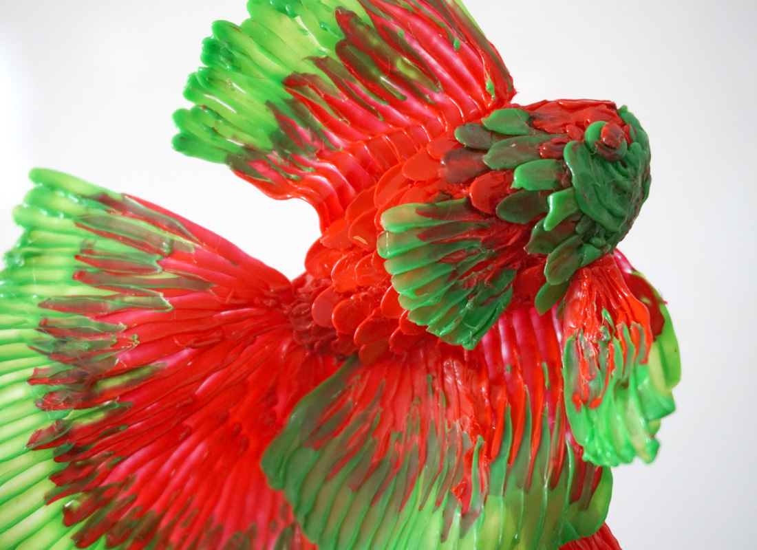 Red and green fish 3D pen art on white surface