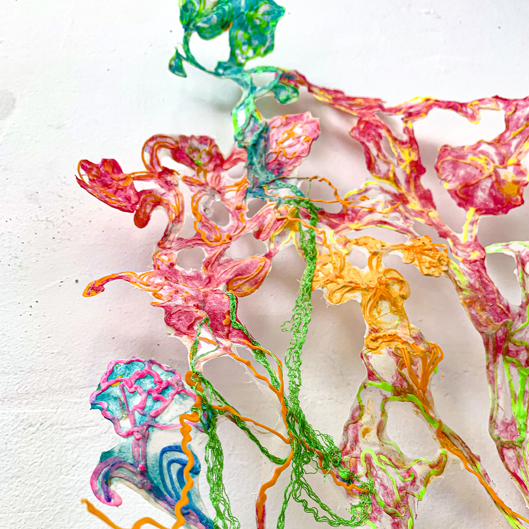 Hand holding 3d pen art: green waxed coin