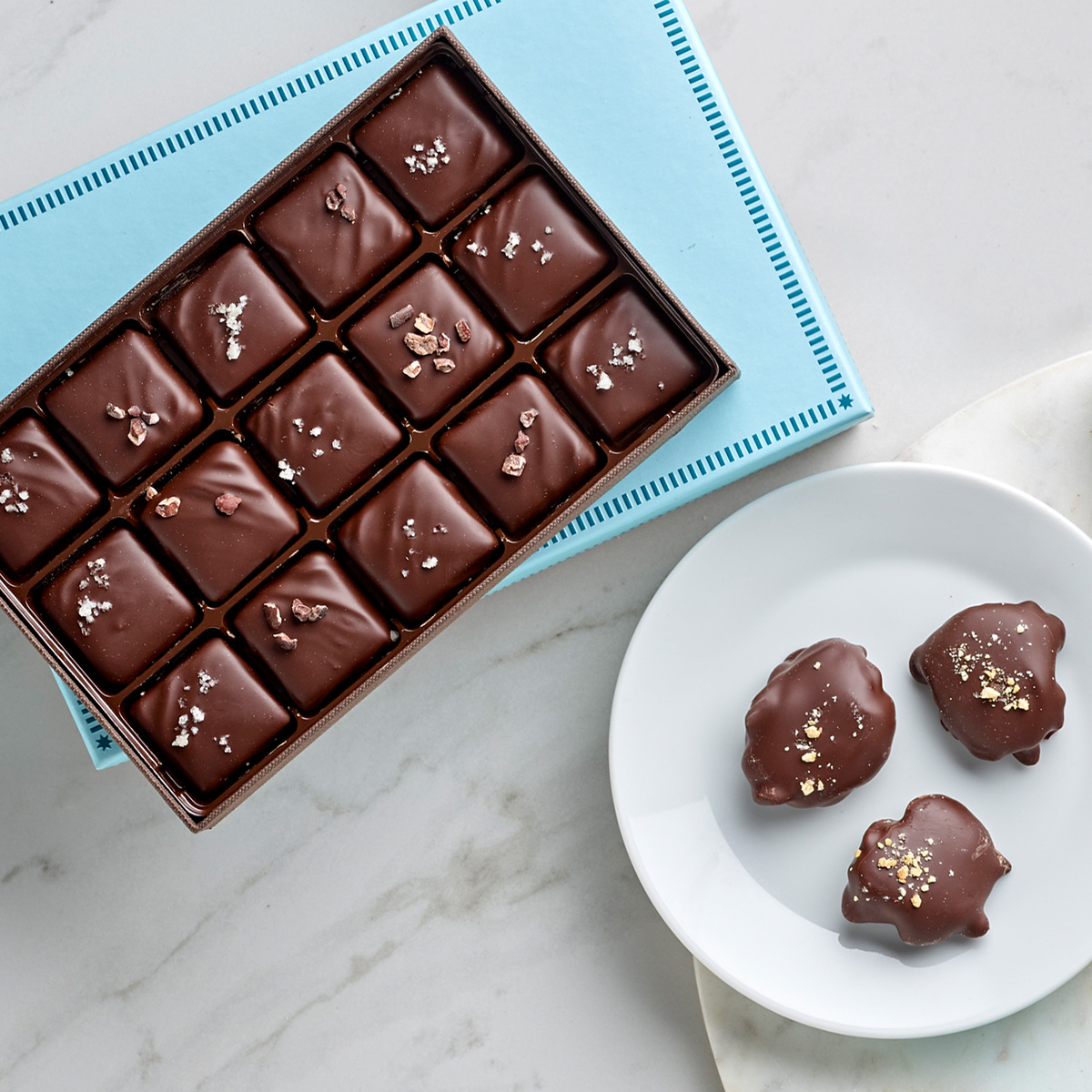 An overhead view of chocolate caramels and some dark chocolate tortoises
