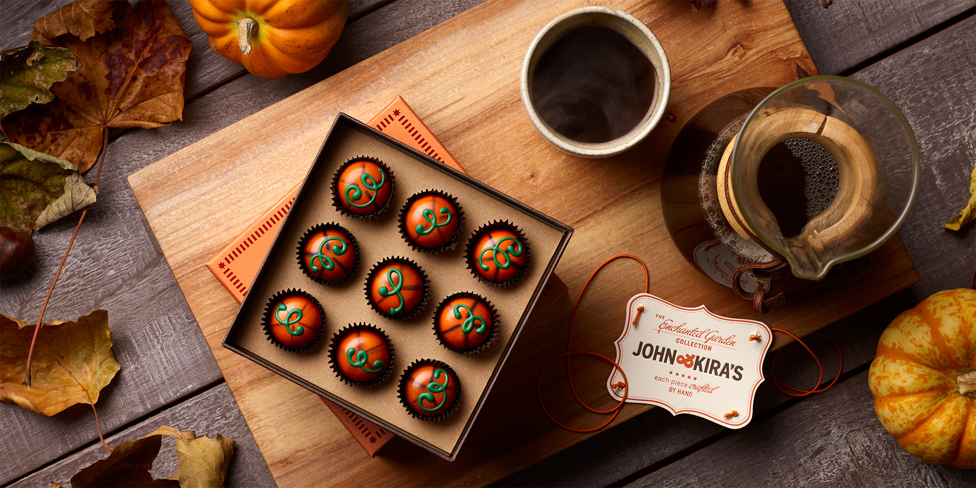 nine festive bright orange chocolate pumpkin bon bons in a square orange box