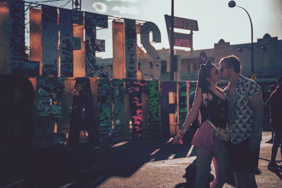 Fans kissing in front of the Life is Beautiful sign 2019