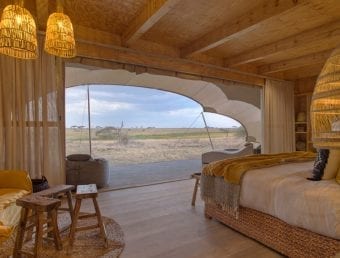 A bedroom looking out into the safari