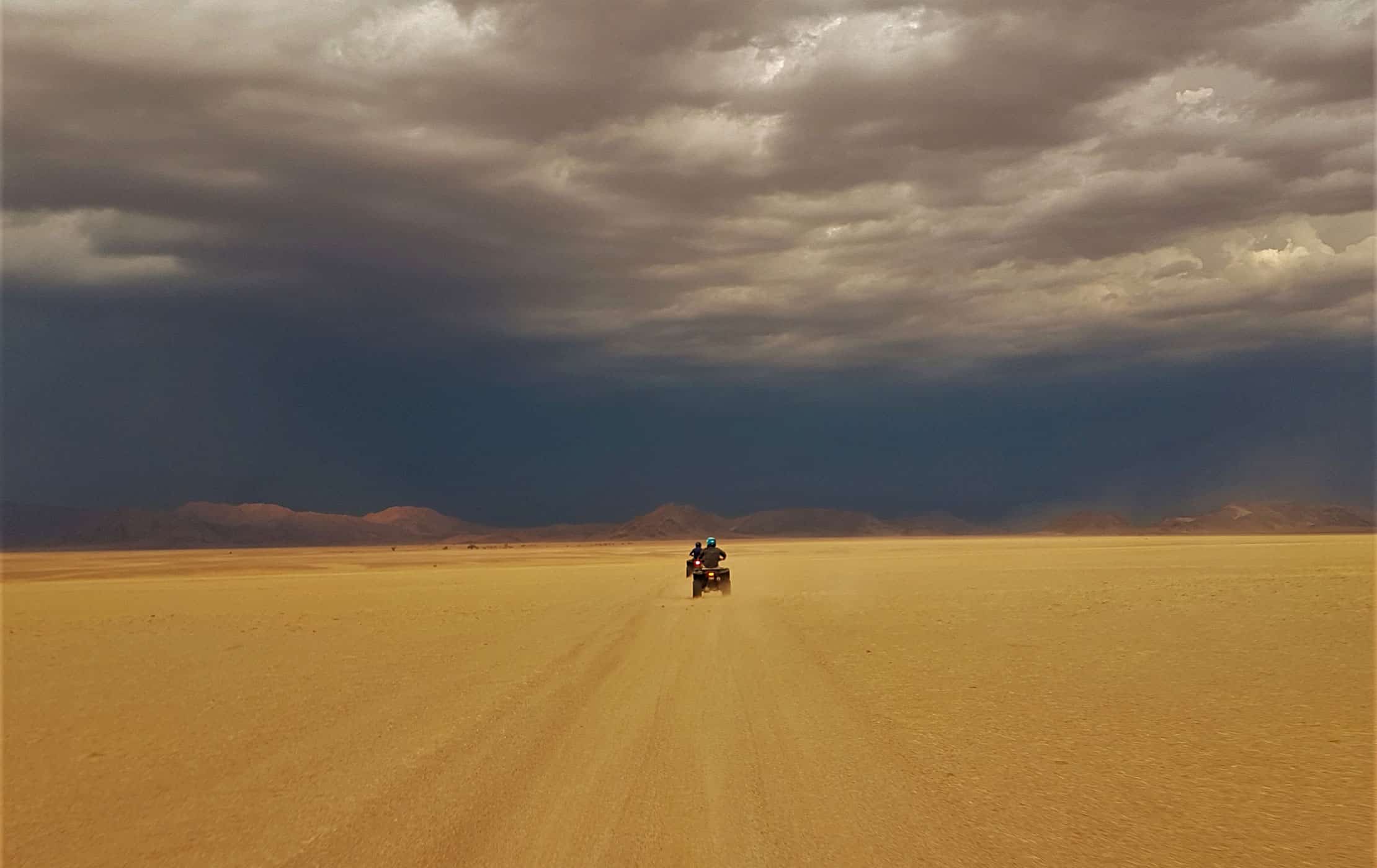A car driving through the desert.