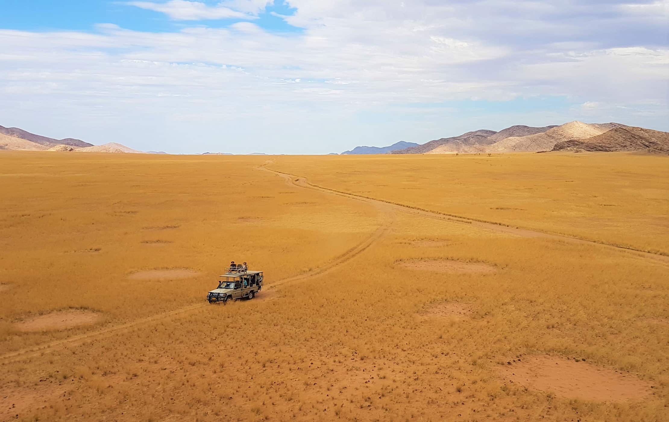 A car driving through a desert.