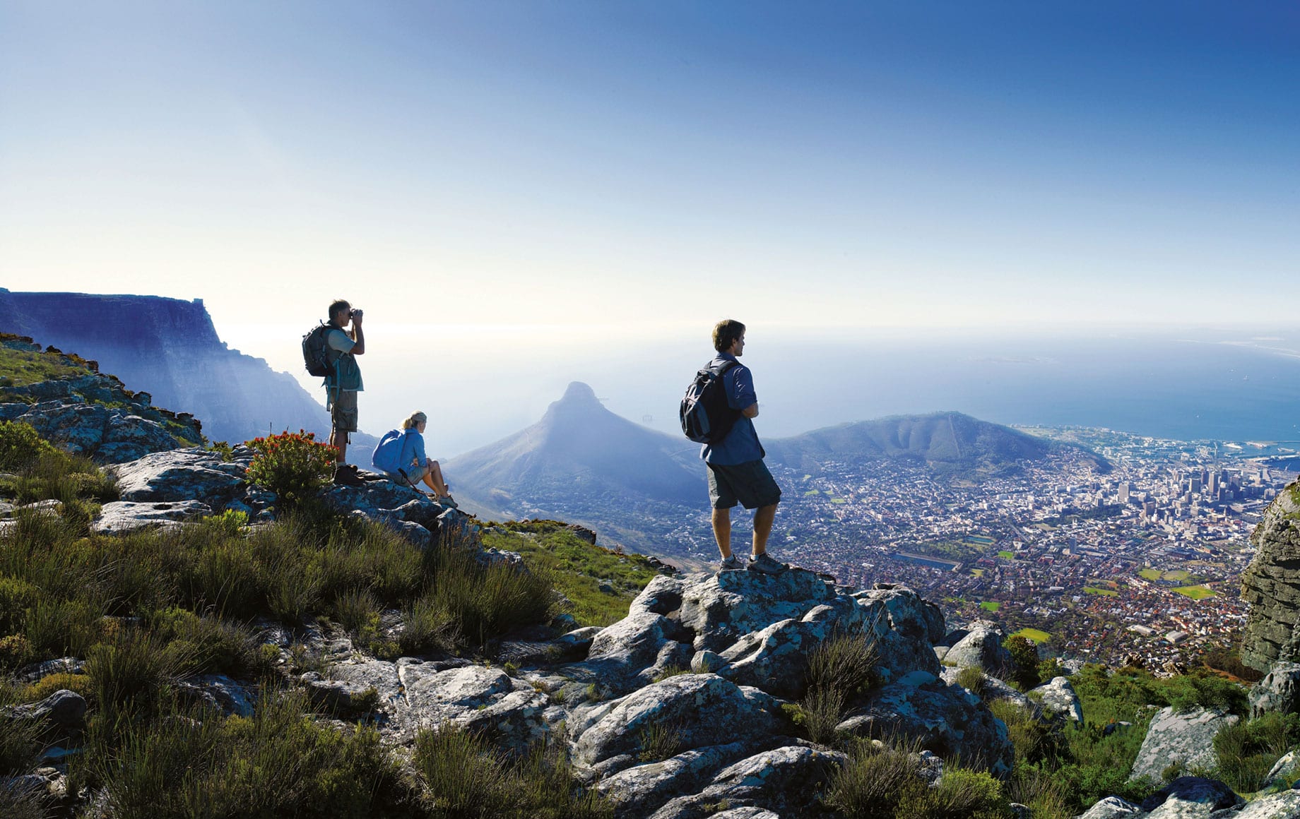 A group of people standing on top of Table Mountain.