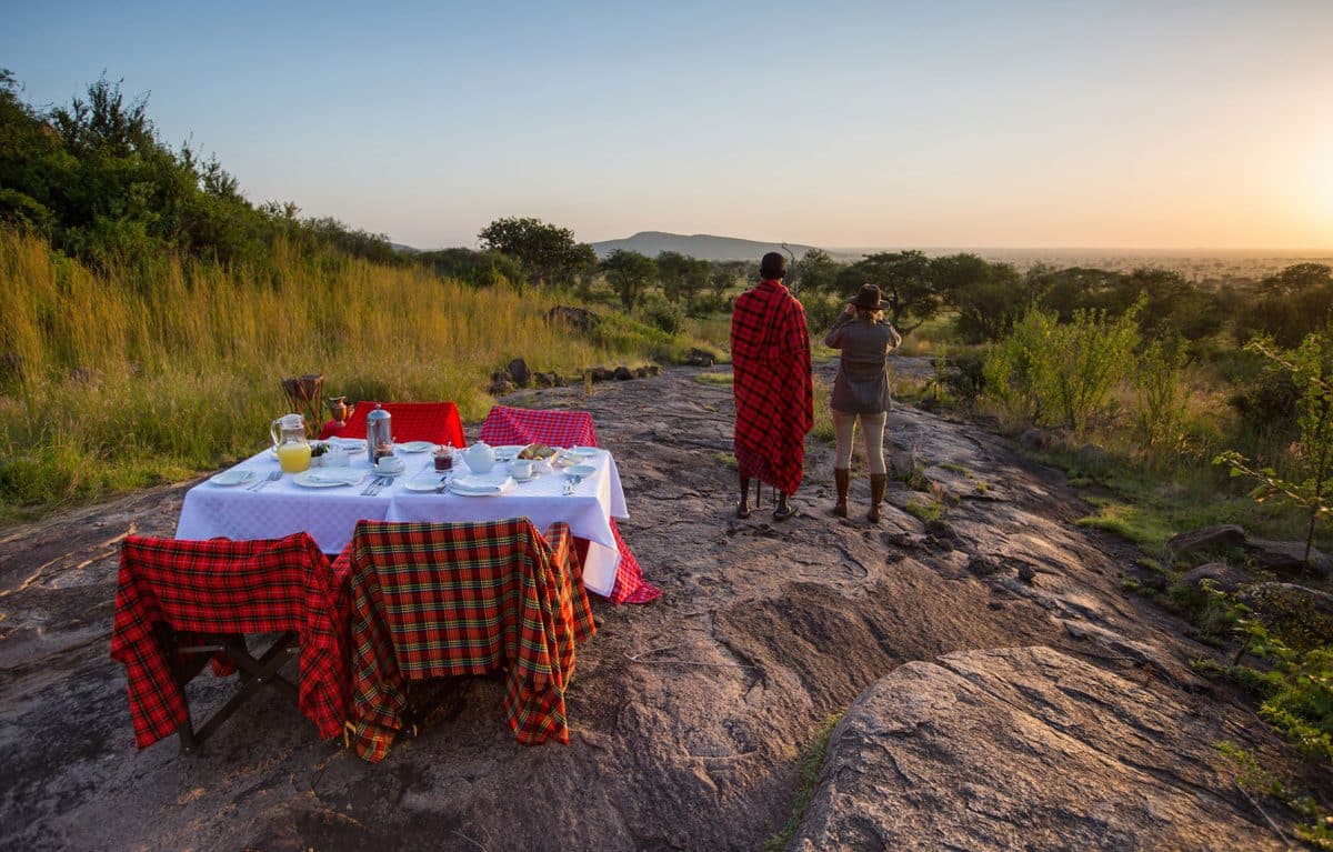 A woman looking through a pair of binoculars at the view.