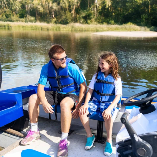 A camper and instructor on a boat.