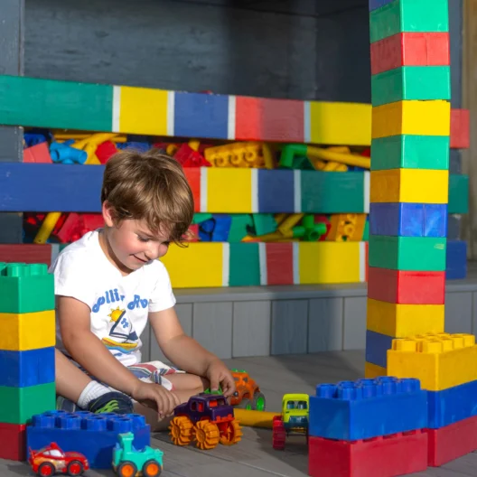 A camper playing with colorful legos.
